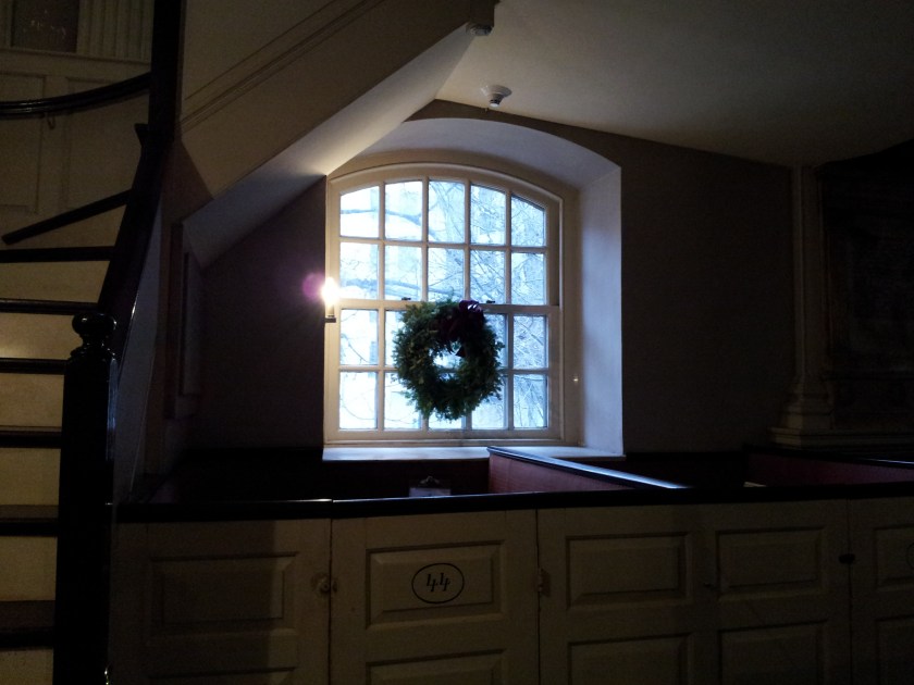 This darkened view is of my "office", the pew in the back where I have a desk and phone.