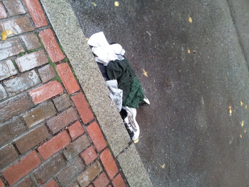 Empty running clothes on top of a pair of running shoes. 