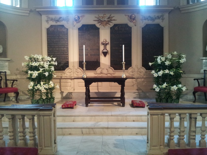 These two racks on either side of the communion table are full of lilies.  