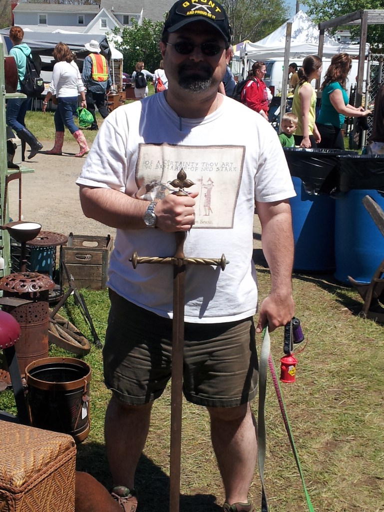 Geoff holds a really long sword.