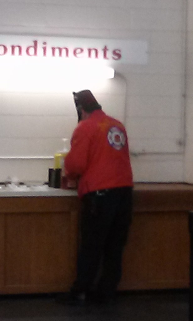 Fez man is getting condiments for his food.