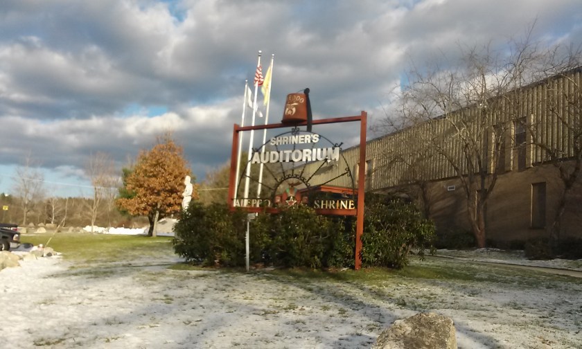Hat-on-a-sign in front of the building.